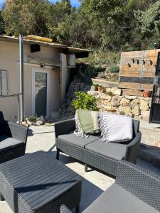 a patio with a couch and a table and a building at Rhône Studio avec terrace parking privé in Viviers
