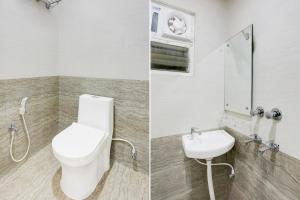 a bathroom with a toilet and a sink at Super Collection O Manikarnika Sahi Near Jagannath Temple in Puri