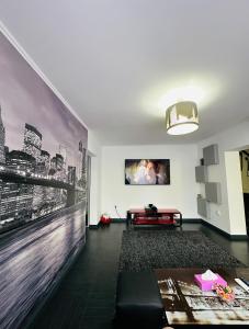 a living room with a large painting on the wall at Apartament 2 camere in Bucharest
