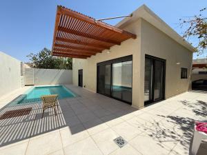 a villa with a swimming pool and a house at Villa In The Deseret - Villa 219 in Beʼer Ora
