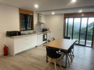 a kitchen with a table and chairs in a room at Gerês View in Geres