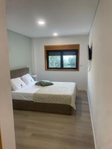 a bedroom with a bed and a window at Gerês View in Geres +19 photos
