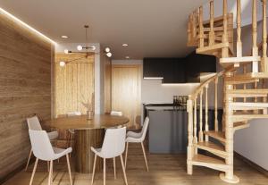 a kitchen and dining room with a wooden table and white chairs at Tarbey Alpine Apartment Leukerbad in Leukerbad