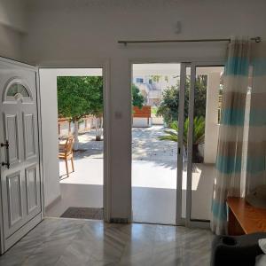 an open door with a view of a patio at ALEX FRUIT TREE HOME in Voroklini +29 photos