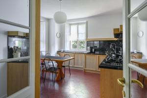 a kitchen with wooden cabinets and a table in it at Luxury Villa at Como Lake in Carate Urio