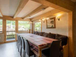 a dining room with a long table and chairs at Chalet 4**** cosy, village, garage, WIFI - FR-1-304-21 in La Clusaz