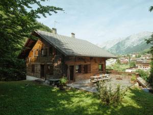 a log cabin in the mountains with a patio at Chalet 4**** cosy, village, garage, WIFI - FR-1-304-21 in La Clusaz