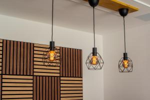three lights are hanging from a wall in a room at Casa Aulaga in Yaiza +24 photos