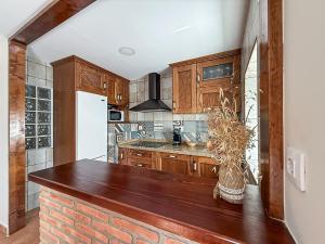 a kitchen with wooden cabinets and a counter top at Apartamento La Plaza in Munera