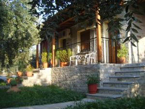 a house with stairs and potted plants on it at Studios Elianthos in Skala Kallirachis