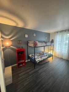 ein Zimmer mit zwei Etagenbetten und einem roten Schrank in der Unterkunft Stelorevan in Bailly-Romainvilliers