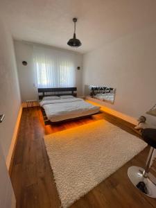 a bedroom with a bed and a white rug at Villa Mali in Ferizaj