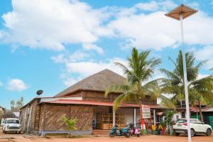 a building with palm trees in front of it at Banalata Resort in Jaypur