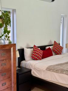 a bedroom with a bed with two pillows on it at Bird Song Bedroom in Cape Town