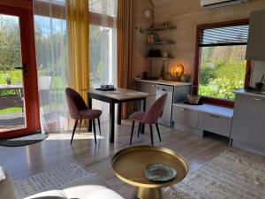 a kitchen with a table and chairs in a room at Beachboog LAHEMAA in Kuusalu