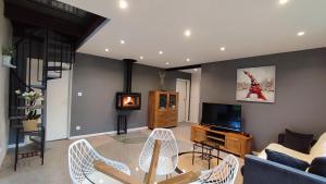 a living room with a couch and a tv at Un Air D'alsace in Rimbach-près-Guebwiller