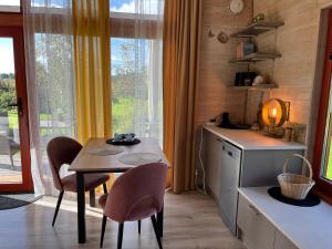 a kitchen with a table and chairs and a dining room at Beachboog LAHEMAA in Kuusalu