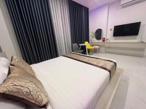 a hotel room with a bed and a television at The Luxury Hotel in Ho Chi Minh City +18 photos