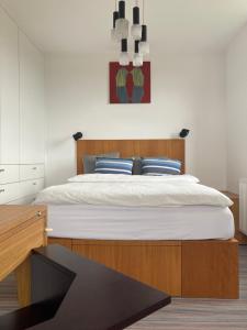 a bedroom with a large bed with a wooden headboard at Baťovský domek in Zlín