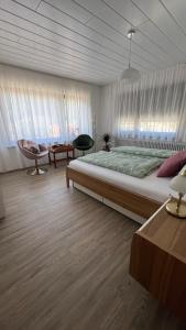 a bedroom with a large bed and a large window at Bachnixe 1 in Seebach