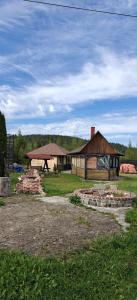 a building with a pavilion and some bricks in a field at Pensiunea Luceafărul, Pasul Mestecăniș in Valea Putnei