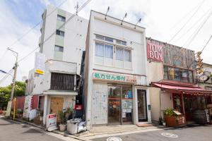 a building on the side of a street at Joyful JUJO Stay 1minute walk from JR Jujo Station Shibuya 15min Shinjuku 11min Ikebukuro 6min Max 6guests 33square meters Simmons bed in Tokyo