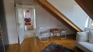 a living room with a couch and a table at Privatzimmer Freimann in Munich