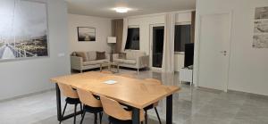 a living room with a wooden table and chairs at Modern Full Comfort Villa in Agnesberg +23 photos