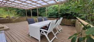 a white table and chairs on a wooden deck at Modern Full Comfort Villa in Agnesberg