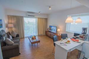 a living room with a couch and a table in a room at Sakura Residence & Hotel in Yangon