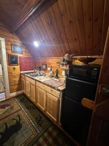 a small kitchen with a sink and a stove at The Drake Cabin in The Forest in Cosby