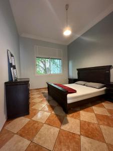 a bedroom with a large bed and a window at Spacious appartment in center harhoura in Temara