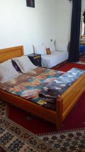 Ένα ή περισσότερα κρεβάτια σε δωμάτιο στο Diabat hostel