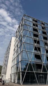 a large glass building with a lot of windows at Short Stay Cosbuc in Baia Mare