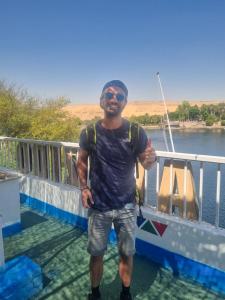 a man giving a thumbs up while standing on a boat at ABAZIDO Nubian Guest House in Aswan