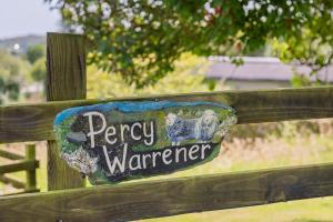 a sign on a wooden fence that readsrey warner at Percy Shepherd's Hut - High Borrans Farm in Ings +1 photo