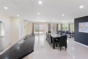 Una cocina y un comedor con mesa y sillas. en Comfortable 4-Bedroom Home with Backyard Escape, en Mount Gambier