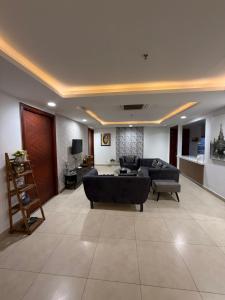 a living room with a couch and a table at Gold Crest Apartments - 1 2 3 4 Bedroom By luxuryapartmentspk in Lahore