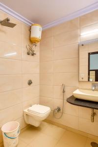 a bathroom with a toilet and a sink at Hotel Vishesh Continental Karol Bagh in New Delhi