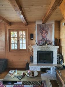 a living room with a fireplace and a picture of a woman at Villa Skyline in Kotor