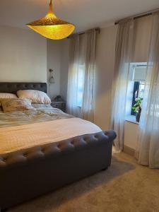 a bedroom with a large bed and a chandelier at 31 Lower English in Armagh