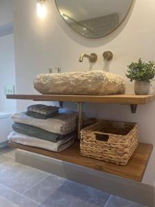 a bathroom with a sink and a shelf with towels at 31 Lower English in Armagh +56 photos