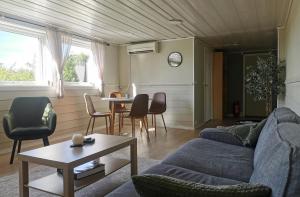a living room with a couch and a table at Spacious, quiet and cosy apartment near Kongeparken & Pulpit Rock in Ålgård