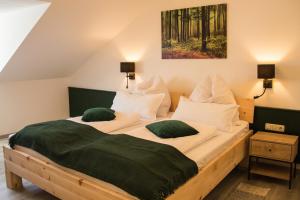 a bedroom with two beds with green pillows at Wohlfühlzimmer "Zirbentraum Kampenwand" - self check-in only, no staff on site in Aschau im Chiemgau