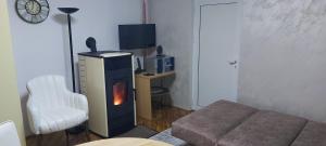 a living room with a couch and a fire place at Novi Pazar Nest Inn in Novi Pazar