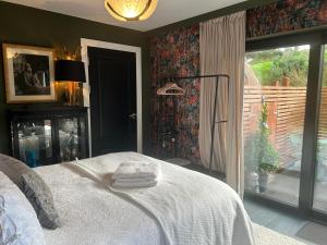 a bedroom with a bed and a large window at The ring fort lodge in Glenties