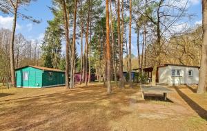 a park with two small houses and a bench at Fh Blau in Warenthin +7 photos