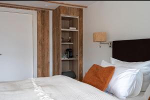 a bedroom with a bed and a book shelf at Alva - Rhön Panorama Ferienhaus in Frankenheim