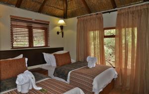 a bedroom with two beds with stuffed animals on them at BushTime Mabula in Mabula +135 photos
