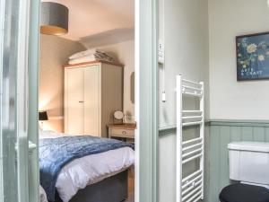 a small bedroom with a bed and a closet at Primrose Cottage in Grassington +8 photos